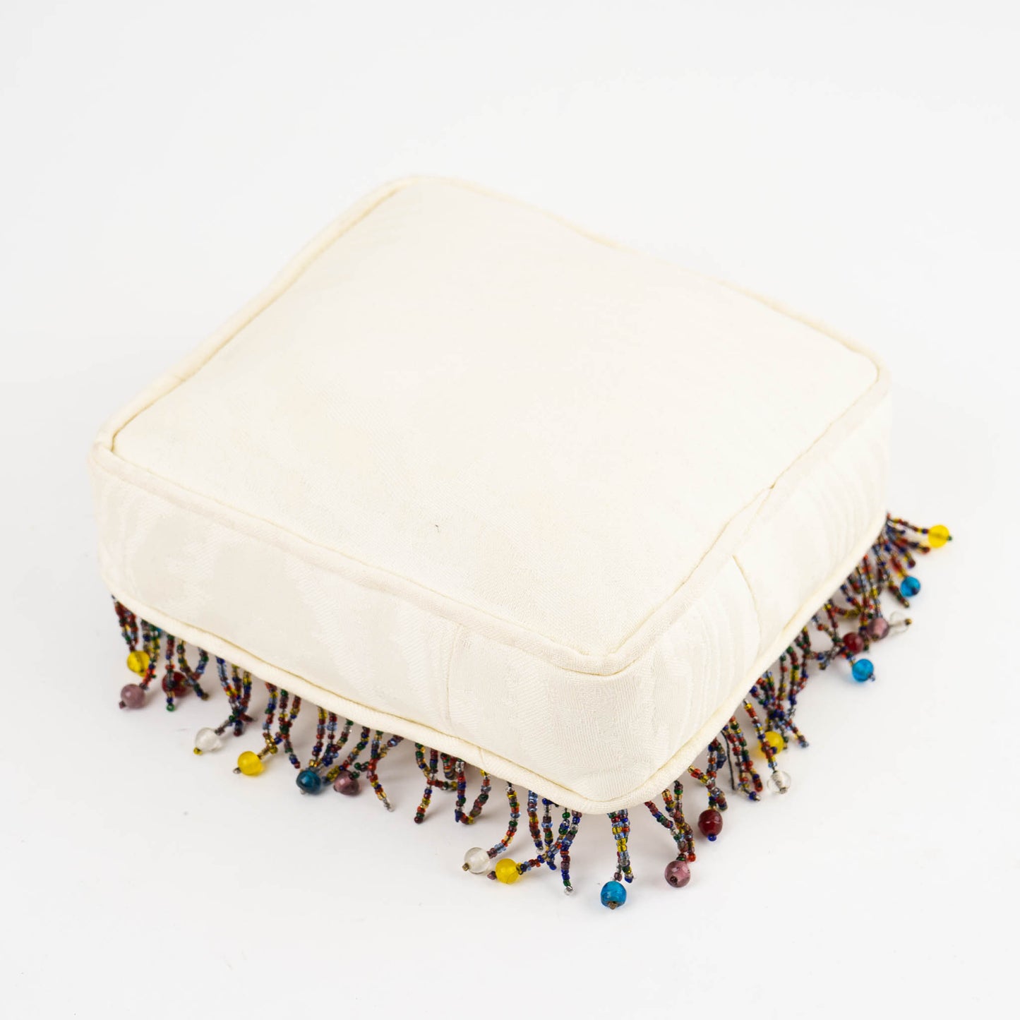 Vintage square needlepoint pillow with hand-stitched camel design and decorative beaded trim around edges