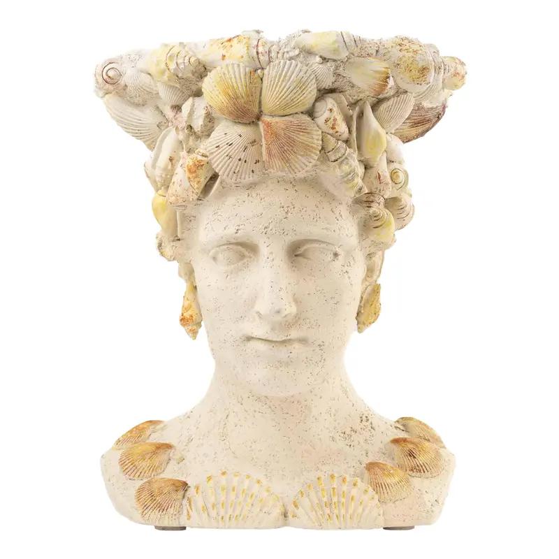 Vintage decorative planter shaped like a female bust covered in seashells with an opening in the head for plants