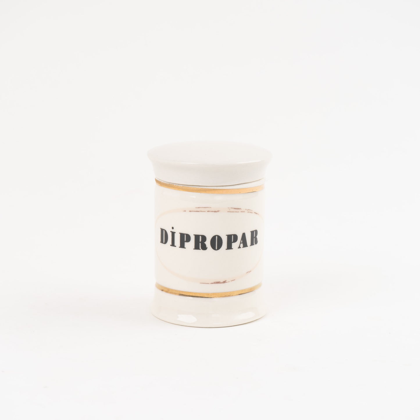 Dipropar off-white ceramic apothecary jar with gold accents and vintage pharmaceutical-style lettering, with matching lid