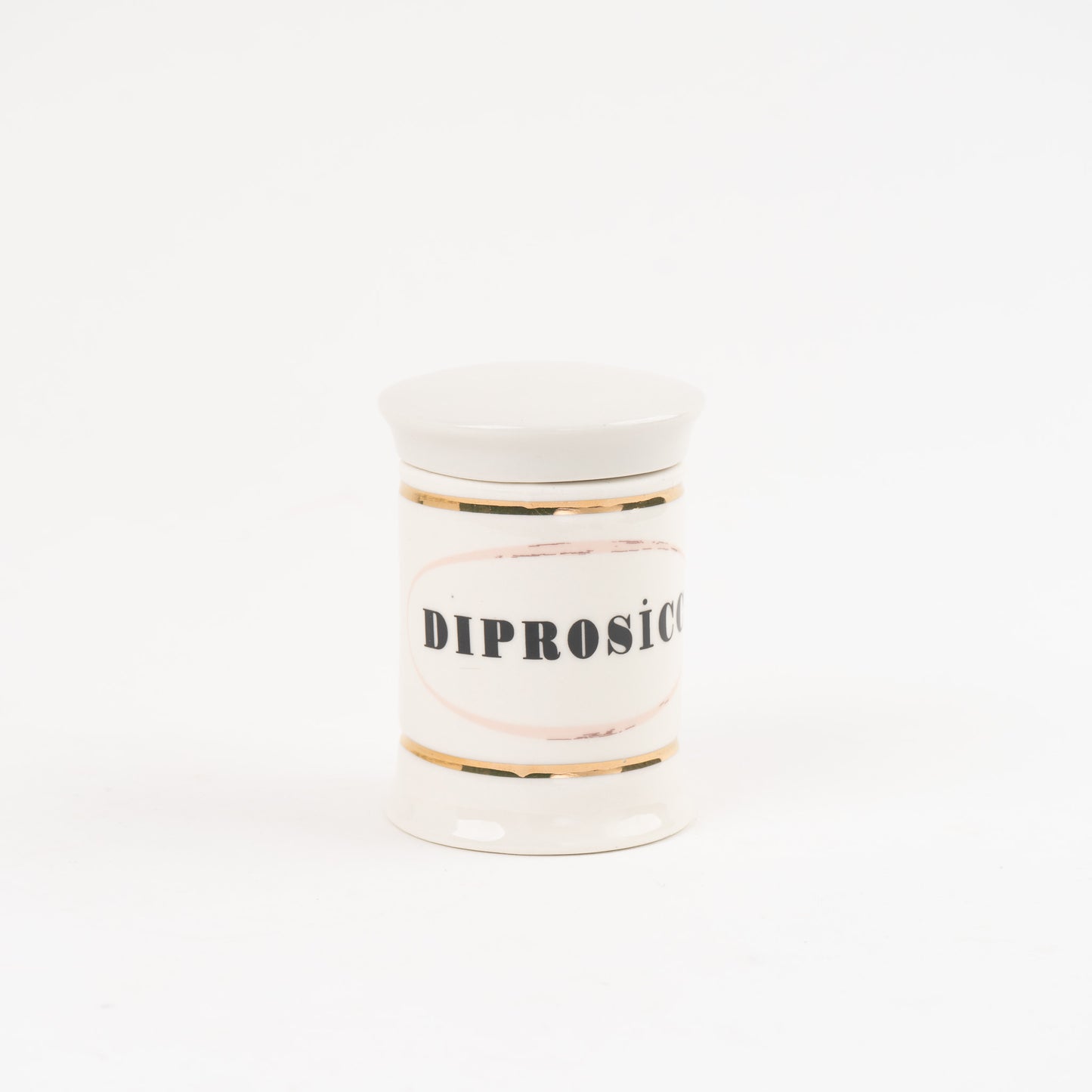 Diprosicc off-white ceramic apothecary jar with gold accents and vintage pharmaceutical-style lettering, with matching lid