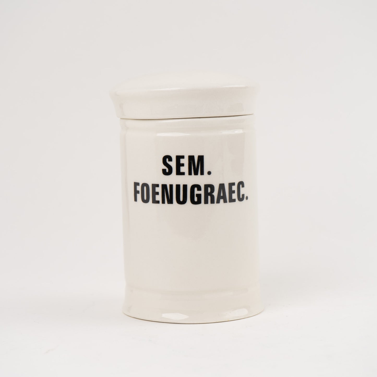 Sem Foenugraec  Off-white ceramic apothecary jar with black vintage lettering and matching lid