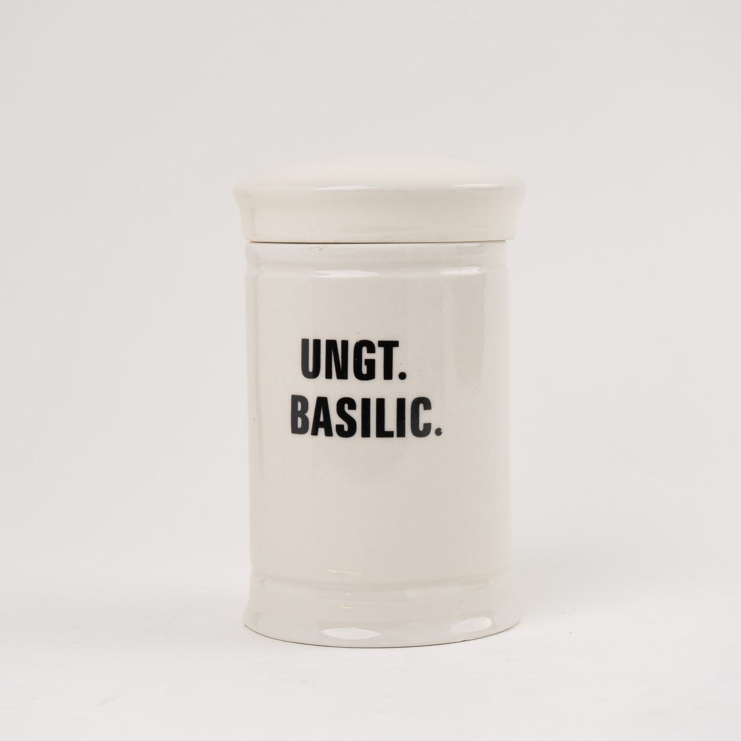 Ungt Basilic Off-white ceramic apothecary jar with black vintage lettering and matching lid