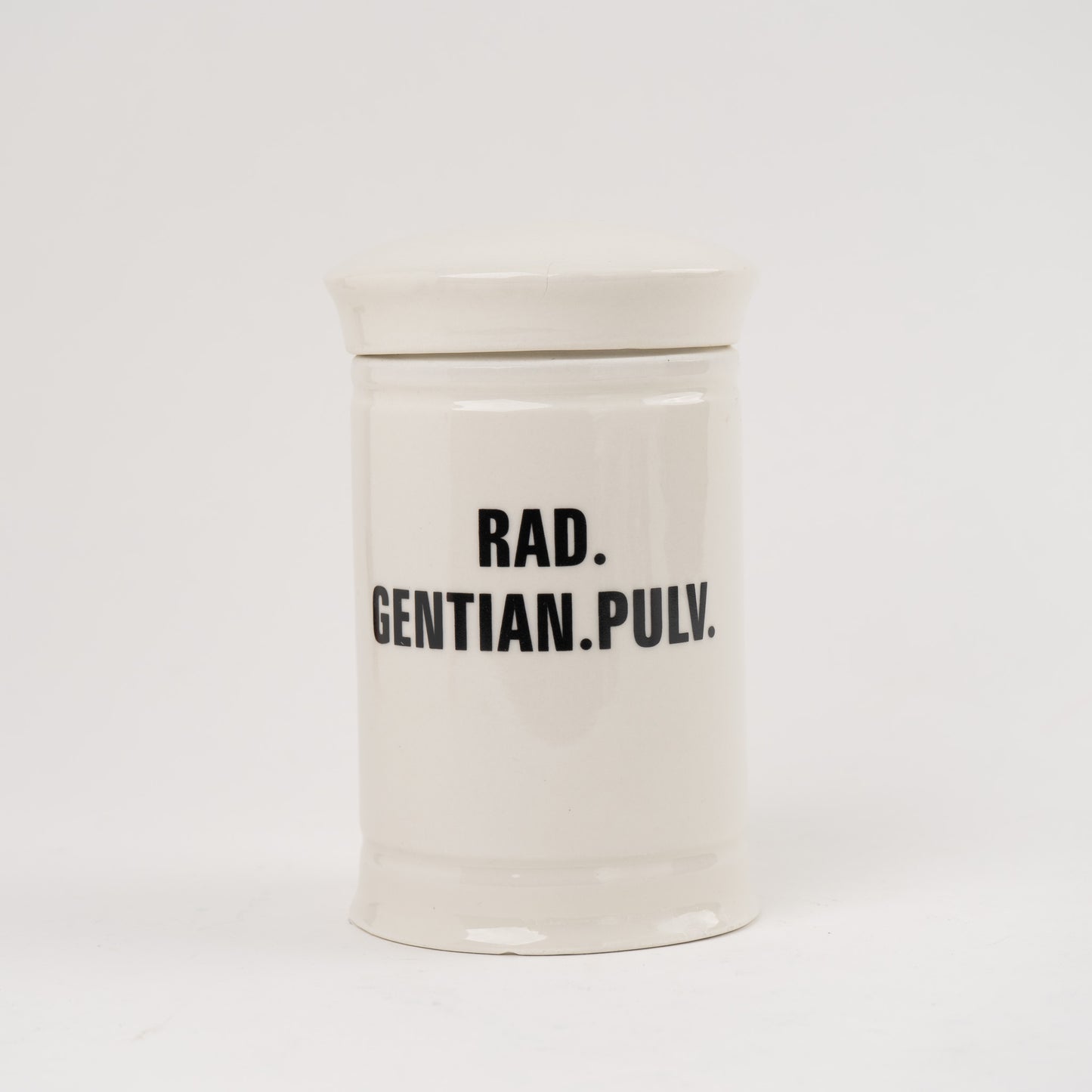 Rad Gentian Pulv  Off-white ceramic apothecary jar with black vintage lettering and matching lid