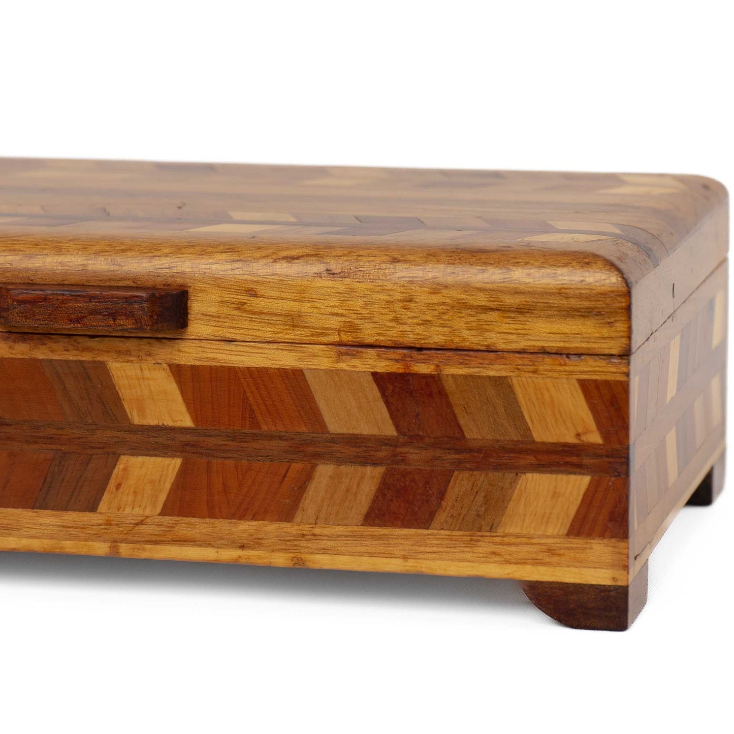 Close-up of herringbone wood inlay pattern on vintage marquetry box