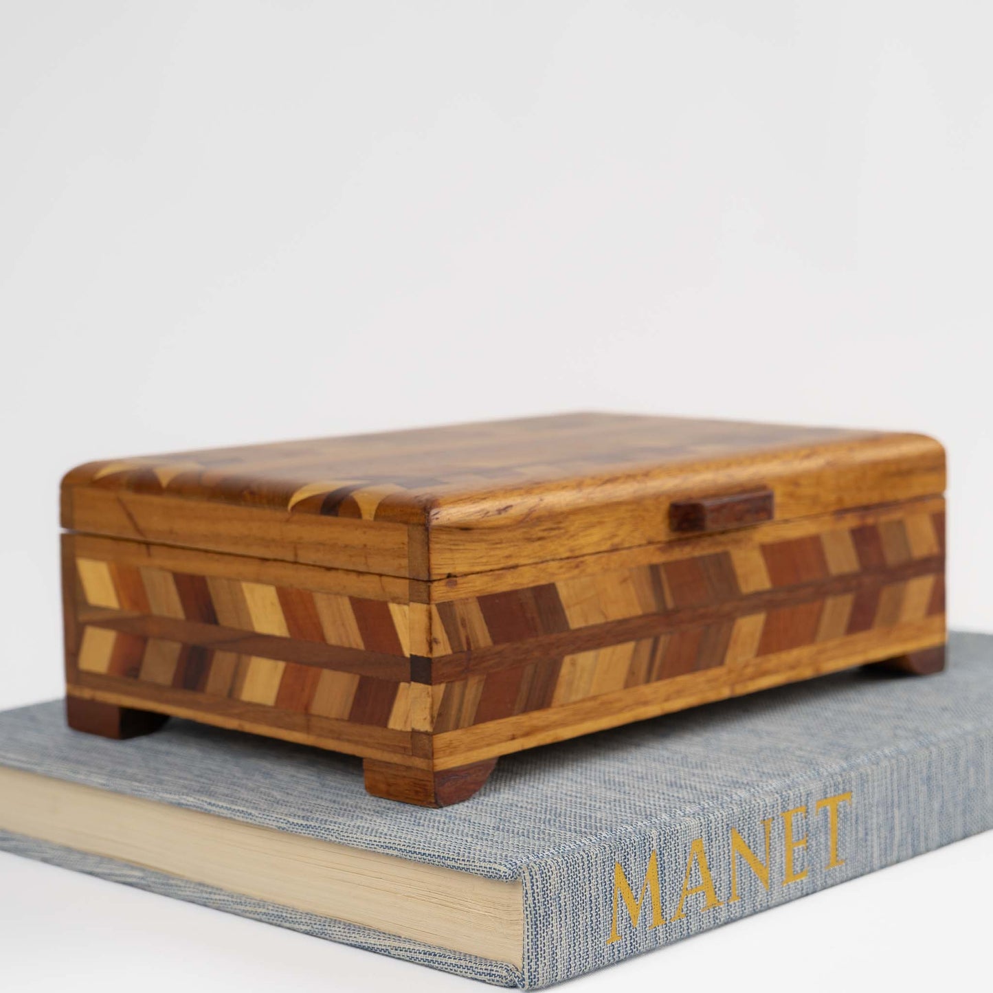 Vintage wood marquetry jewelry box with herringbone inlay pattern and hinged lid