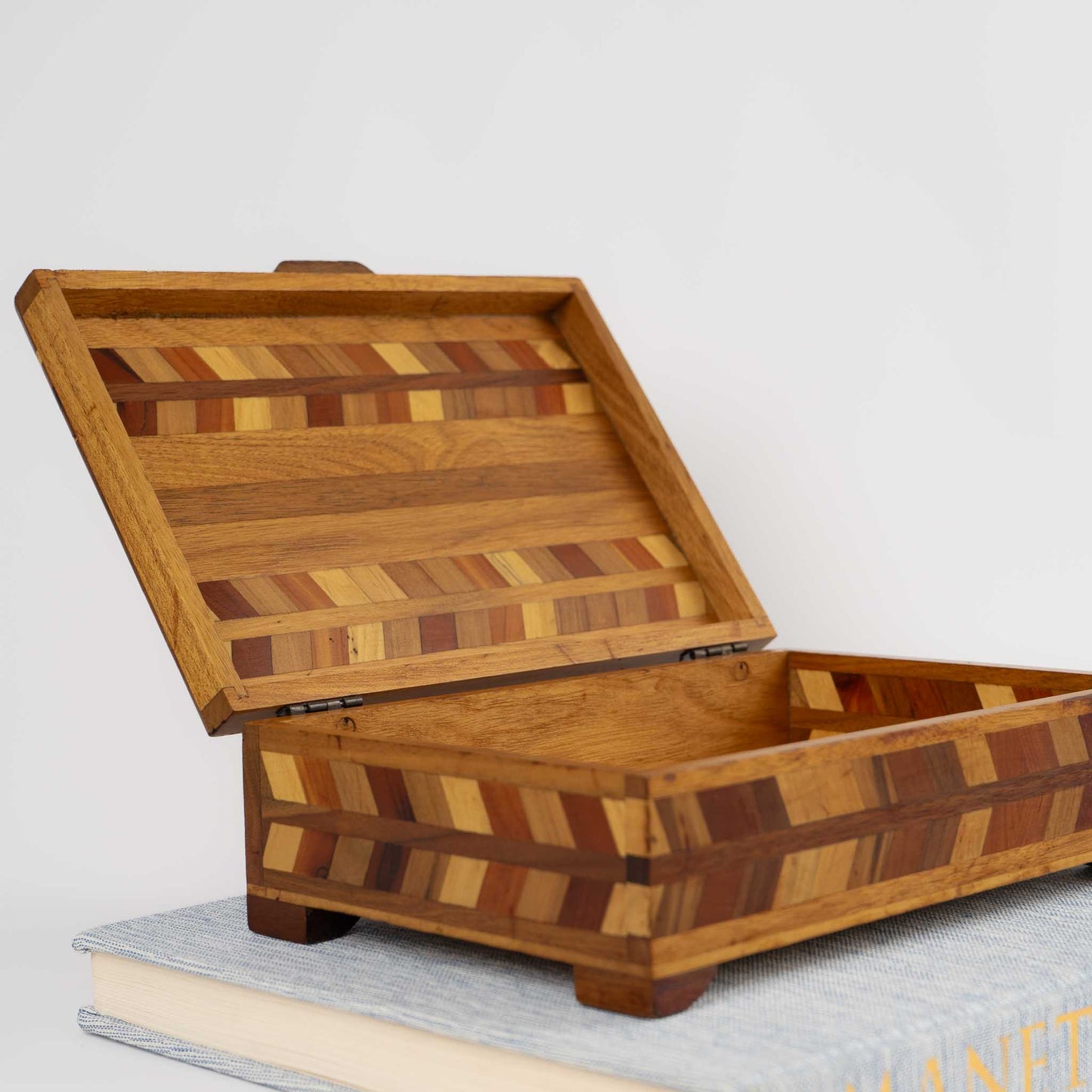Close-up of herringbone wood inlay pattern on vintage marquetry box