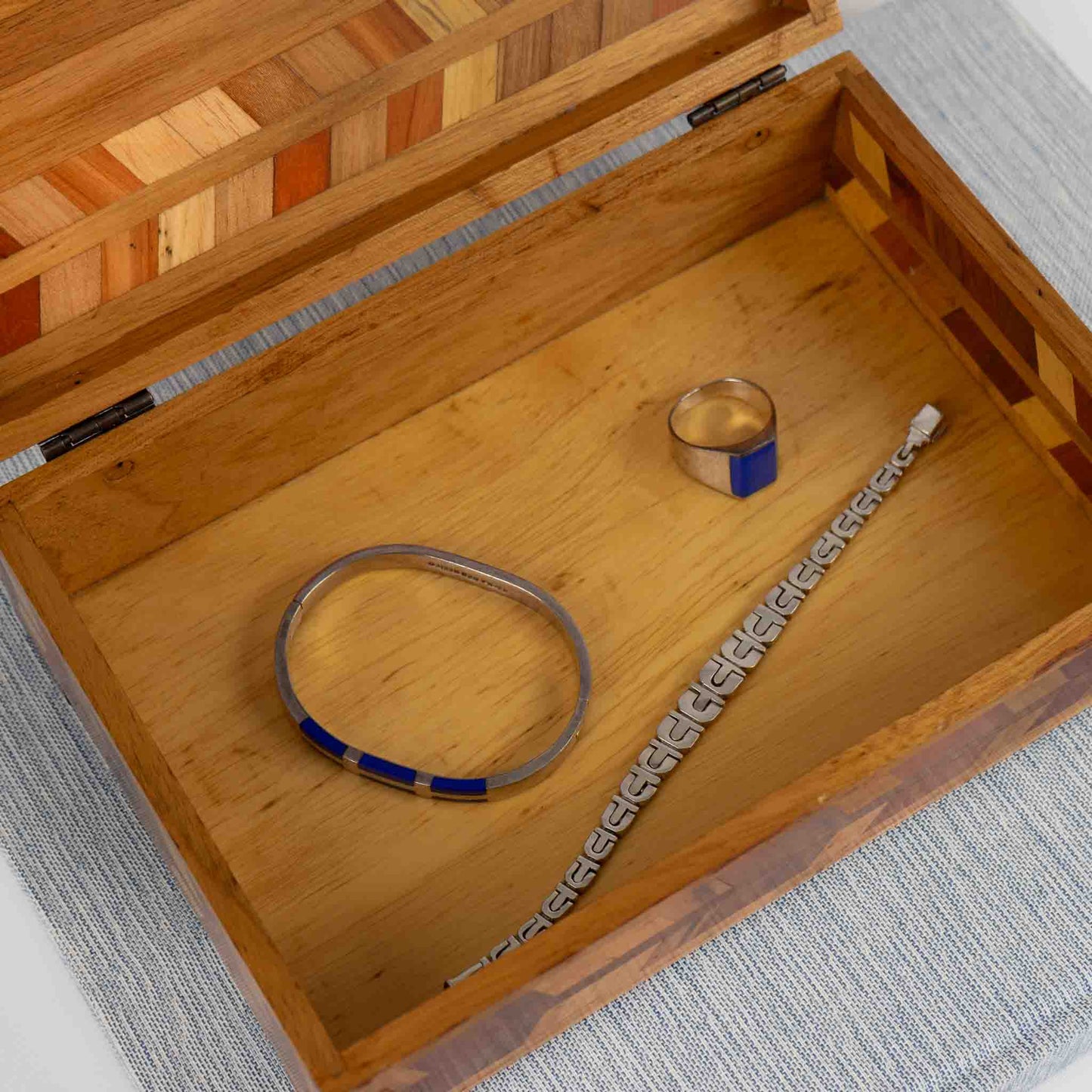 Interior view of vintage wood marquetry jewelry box storage compartment