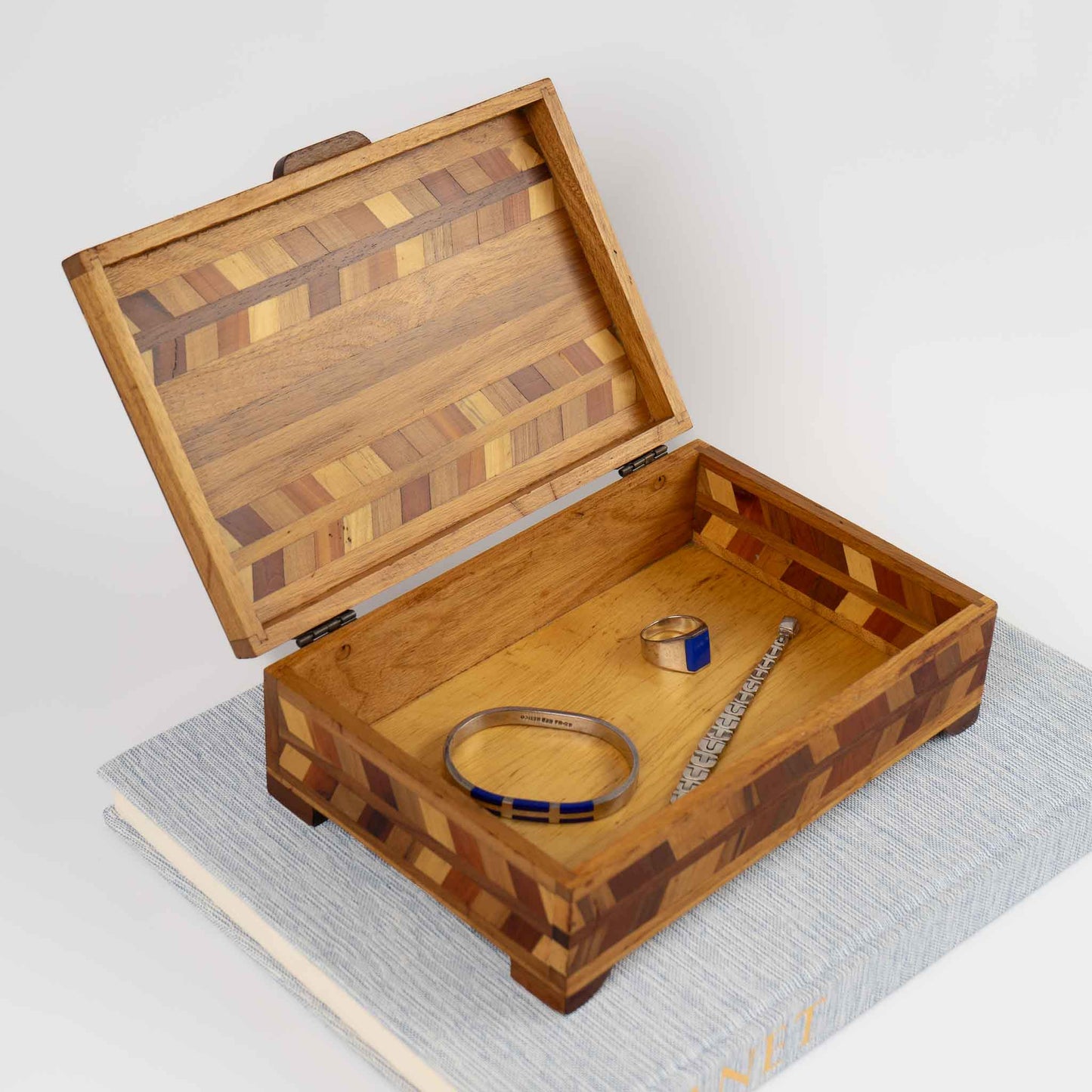 Vintage wood marquetry jewelry box with herringbone inlay pattern and hinged lid