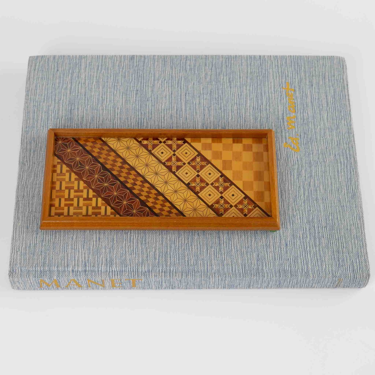 Vintage rectangular wood marquetry tray featuring six geometric patterns with contrasting wood tones and intricate inlay patterns