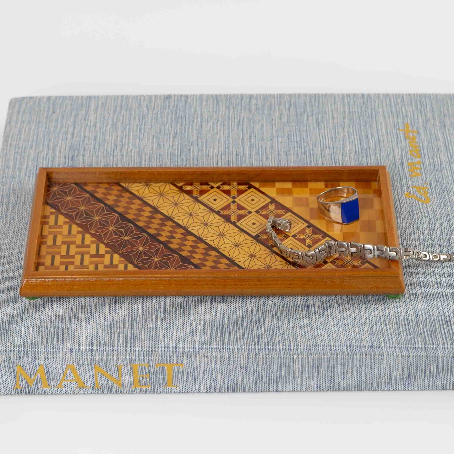 Vintage rectangular wood marquetry tray featuring six geometric patterns with contrasting wood tones and intricate inlay patterns