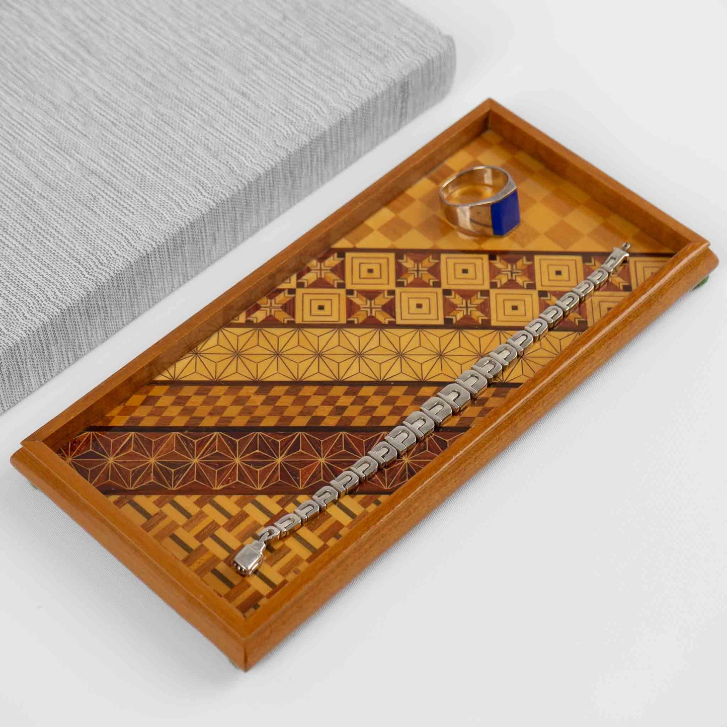 Vintage rectangular wood marquetry tray featuring six geometric patterns with contrasting wood tones and intricate inlay patterns