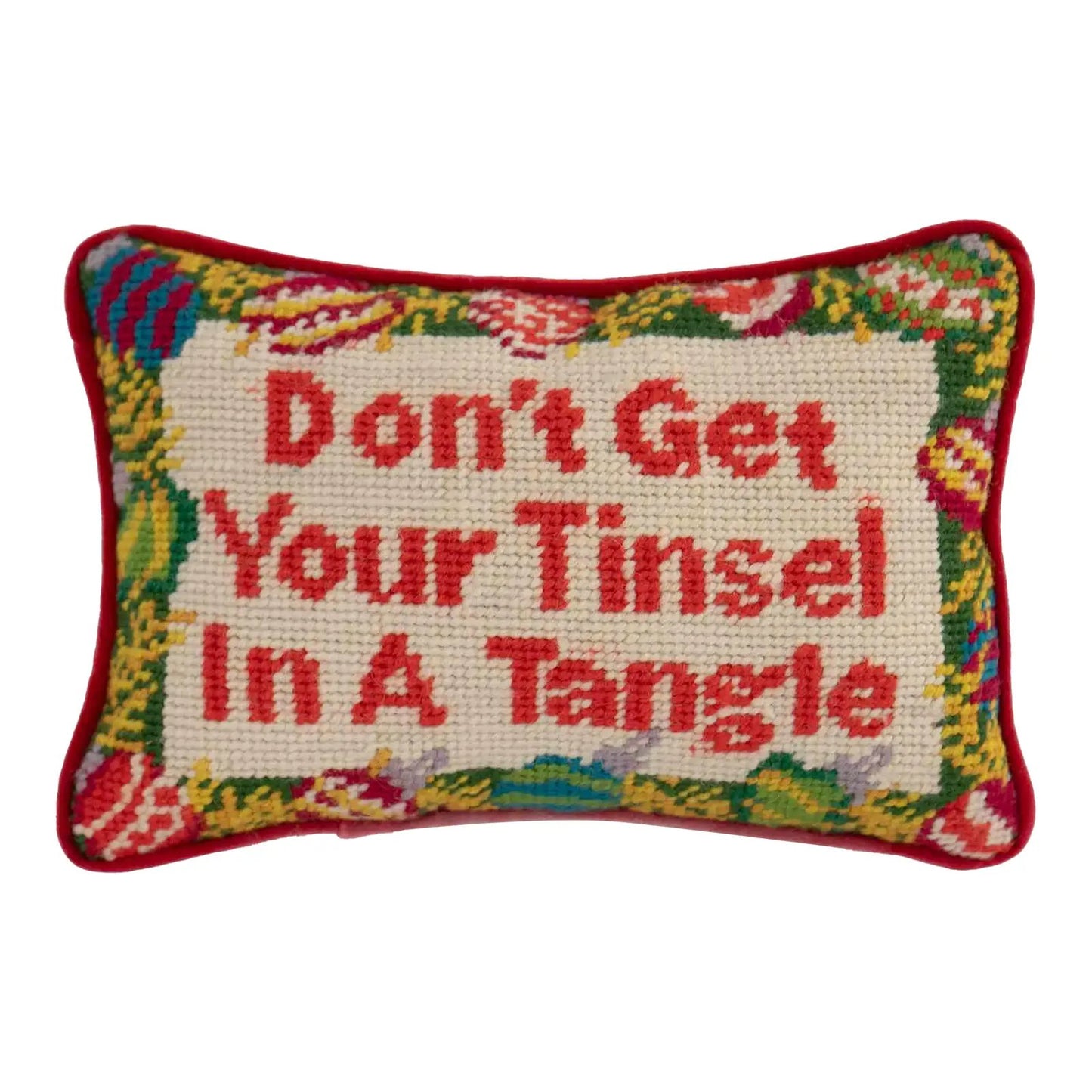 Small vintage needlepoint pillow with "Don't get your tinsel in a tangle" text, Christmas ornament border, red piping, and red velvet back