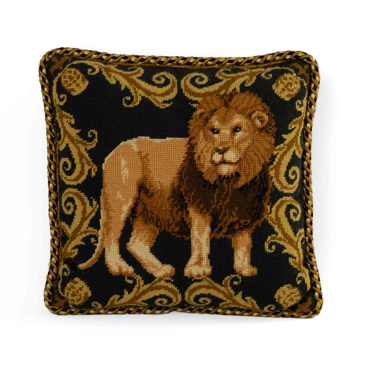 Vintage square needlepoint pillow featuring embroidered lion with decorative scroll border and braided rope piping