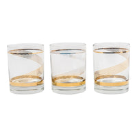 Three vintage lowball cocktail glasses with gold swirl band pattern on clear glass