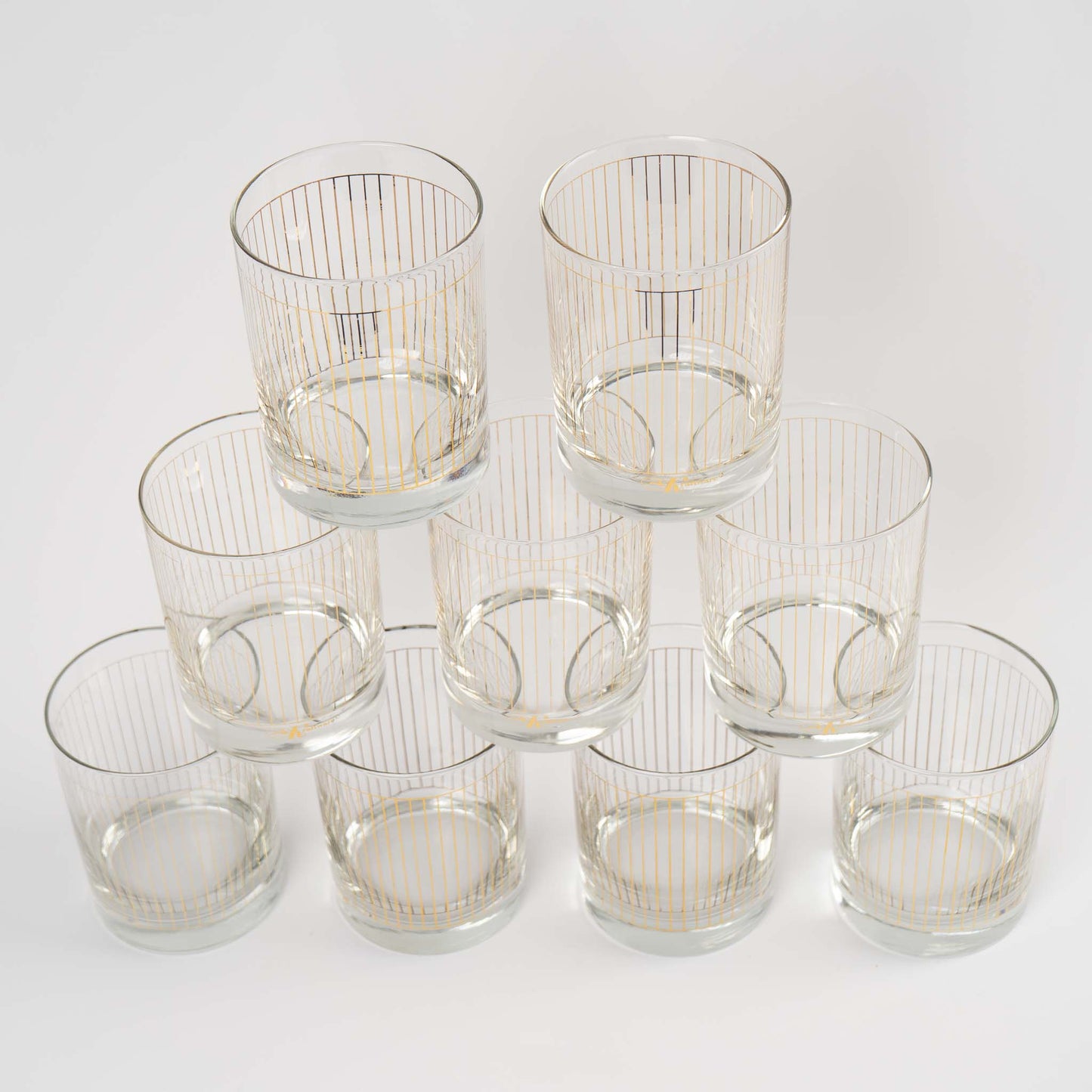 Vintage lowball glasses with thin gold stripe pattern, set of 9 pieces marked Kraftware from 1960s-1970s