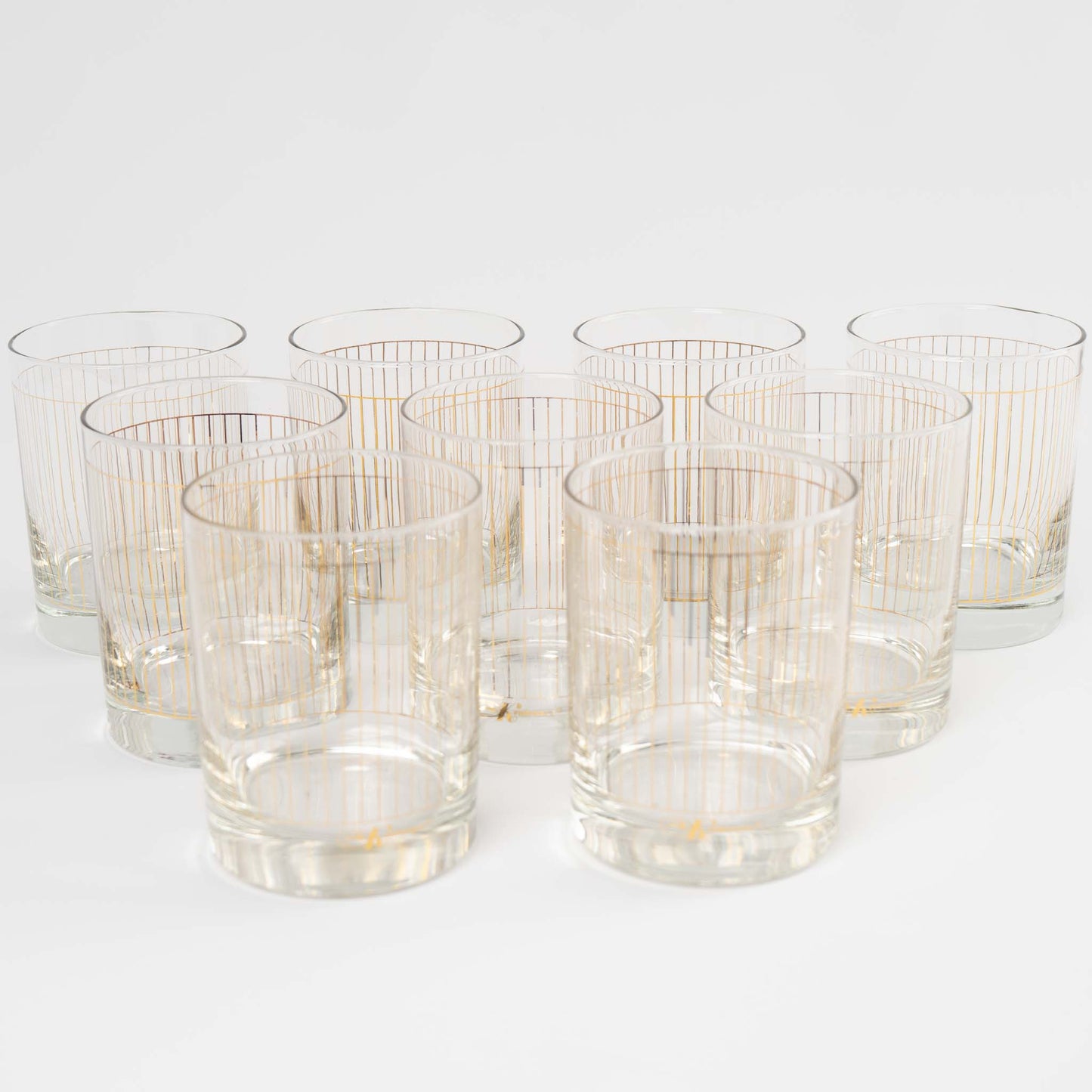 Vintage lowball glasses with thin gold stripe pattern, set of 9 pieces marked Kraftware from 1960s-1970s