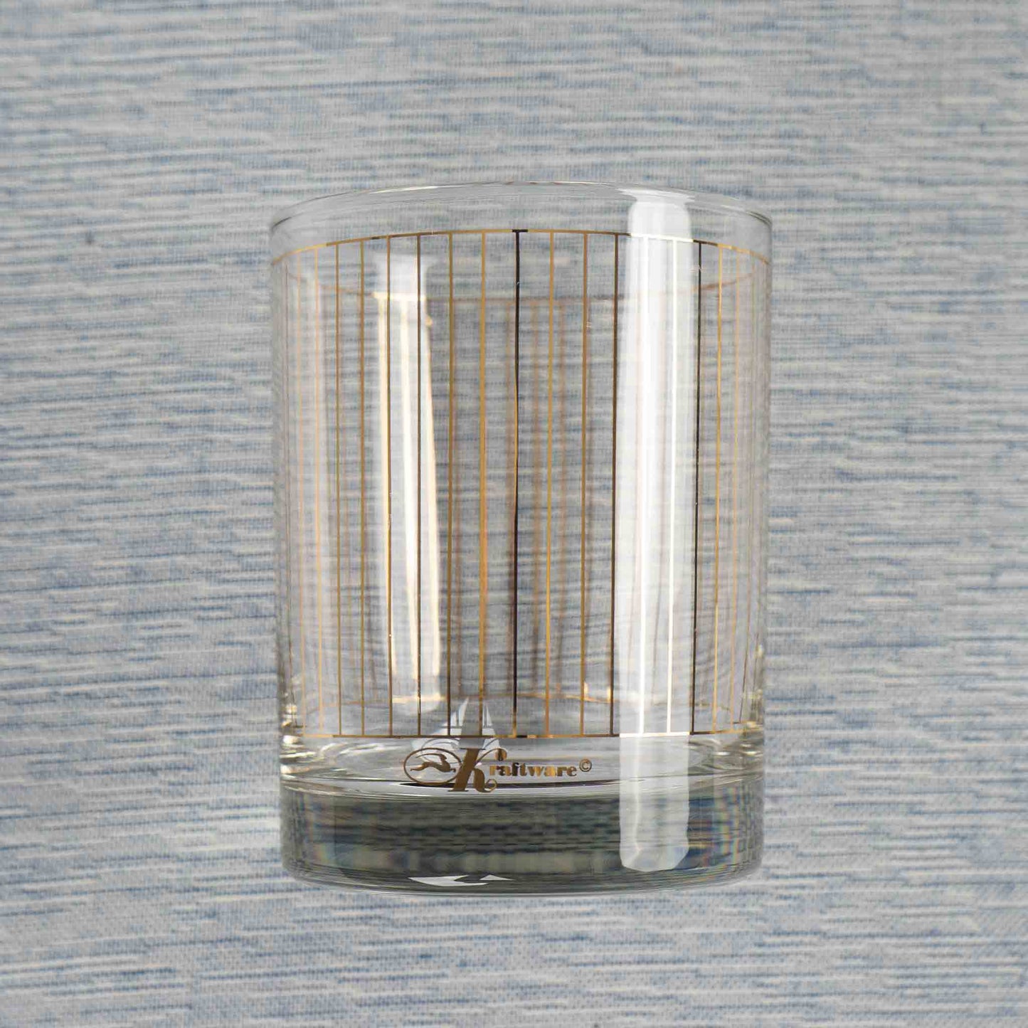 Vintage lowball glasses with thin gold stripe pattern, set of 9 pieces marked Kraftware from 1960s-1970s