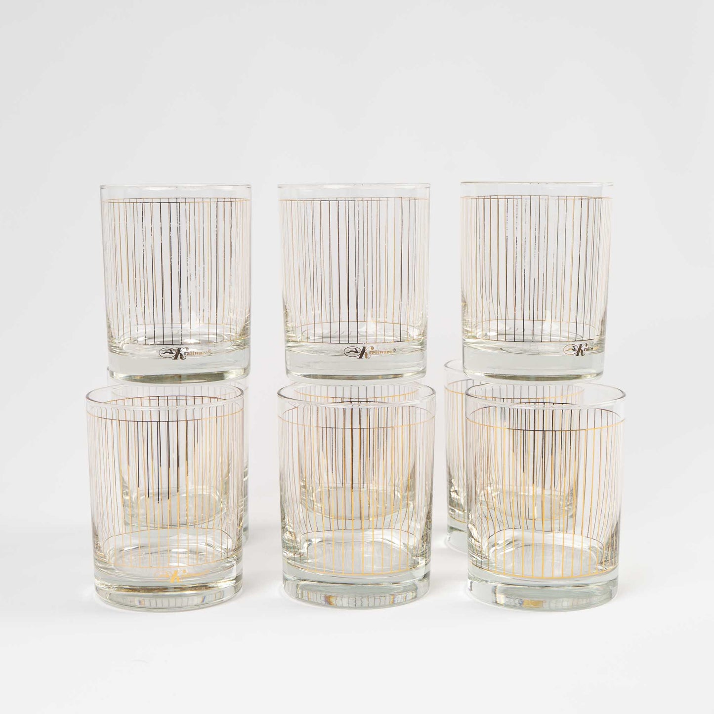 Vintage lowball glasses with thin gold stripe pattern, set of 9 pieces marked Kraftware from 1960s-1970s
