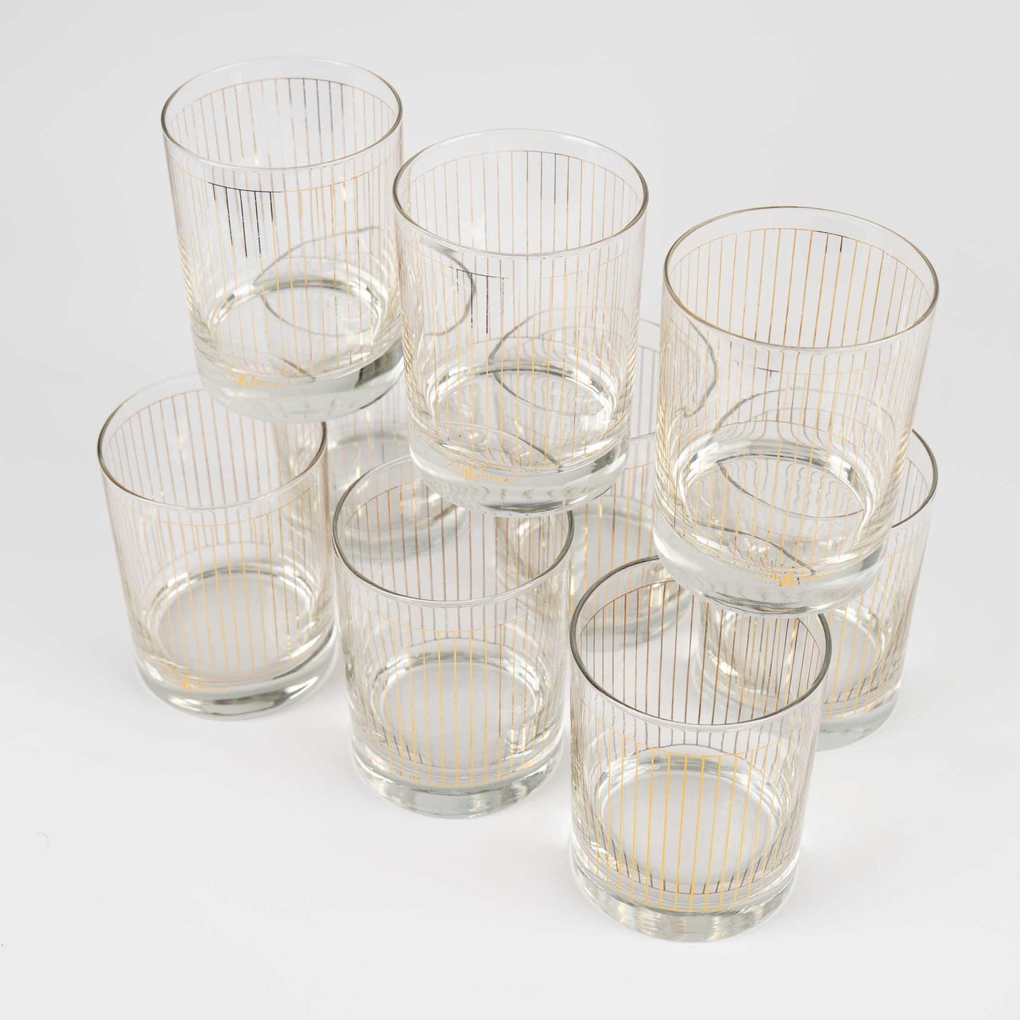 Vintage lowball glasses with thin gold stripe pattern, set of 9 pieces marked Kraftware from 1960s-1970s