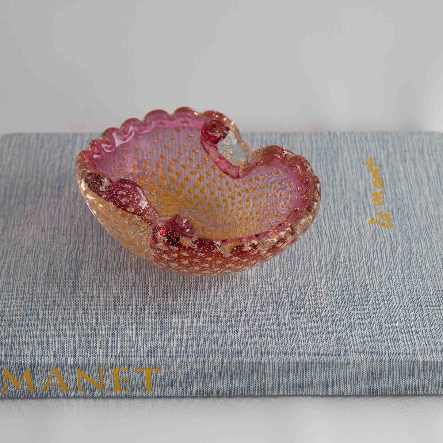 Vintage Murano Bullicante art glass catchall dish in pink and yellow with gold aventurine flecks and scalloped edge