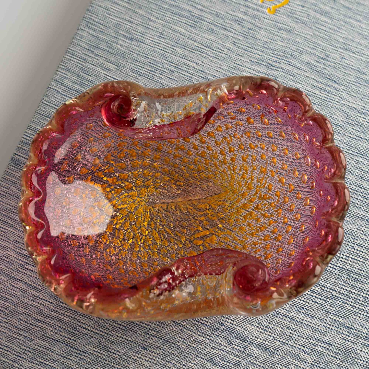 Vintage Murano Bullicante art glass catchall dish in pink and yellow with gold aventurine flecks and scalloped edge