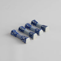 Set of four vintage porcelain chopstick rests in a traditional chinoiserie blue and white pattern