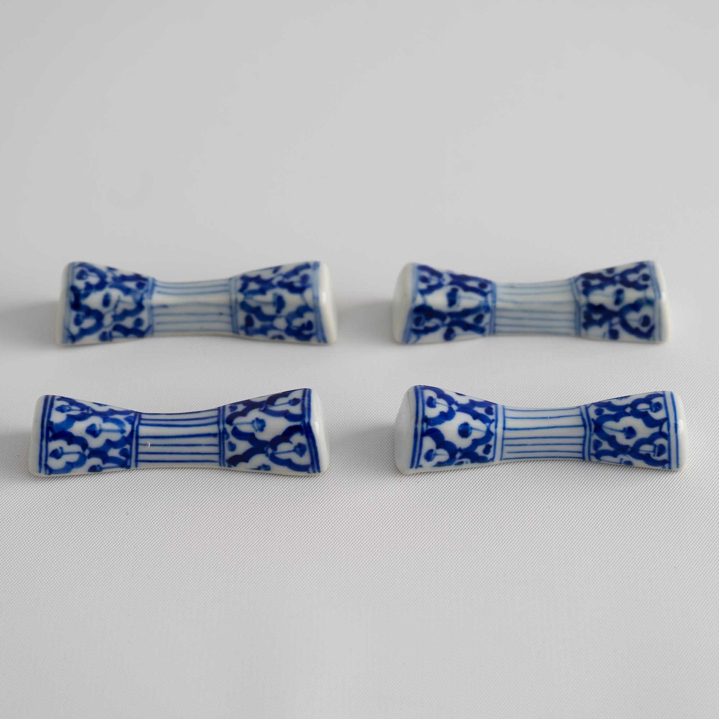 Set of four vintage porcelain chopstick rests in a traditional chinoiserie blue and white pattern 