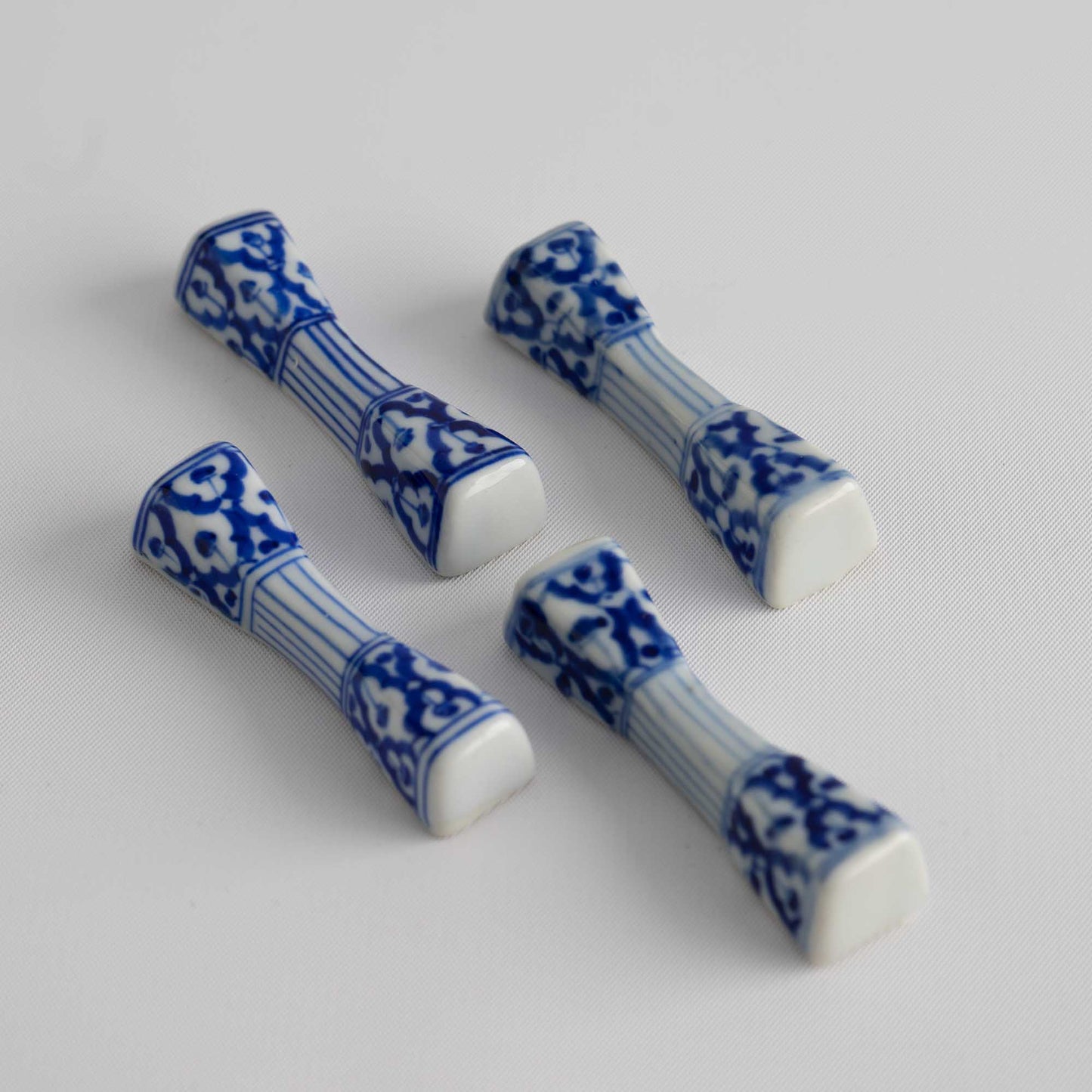Set of four vintage porcelain chopstick rests in a traditional chinoiserie blue and white pattern