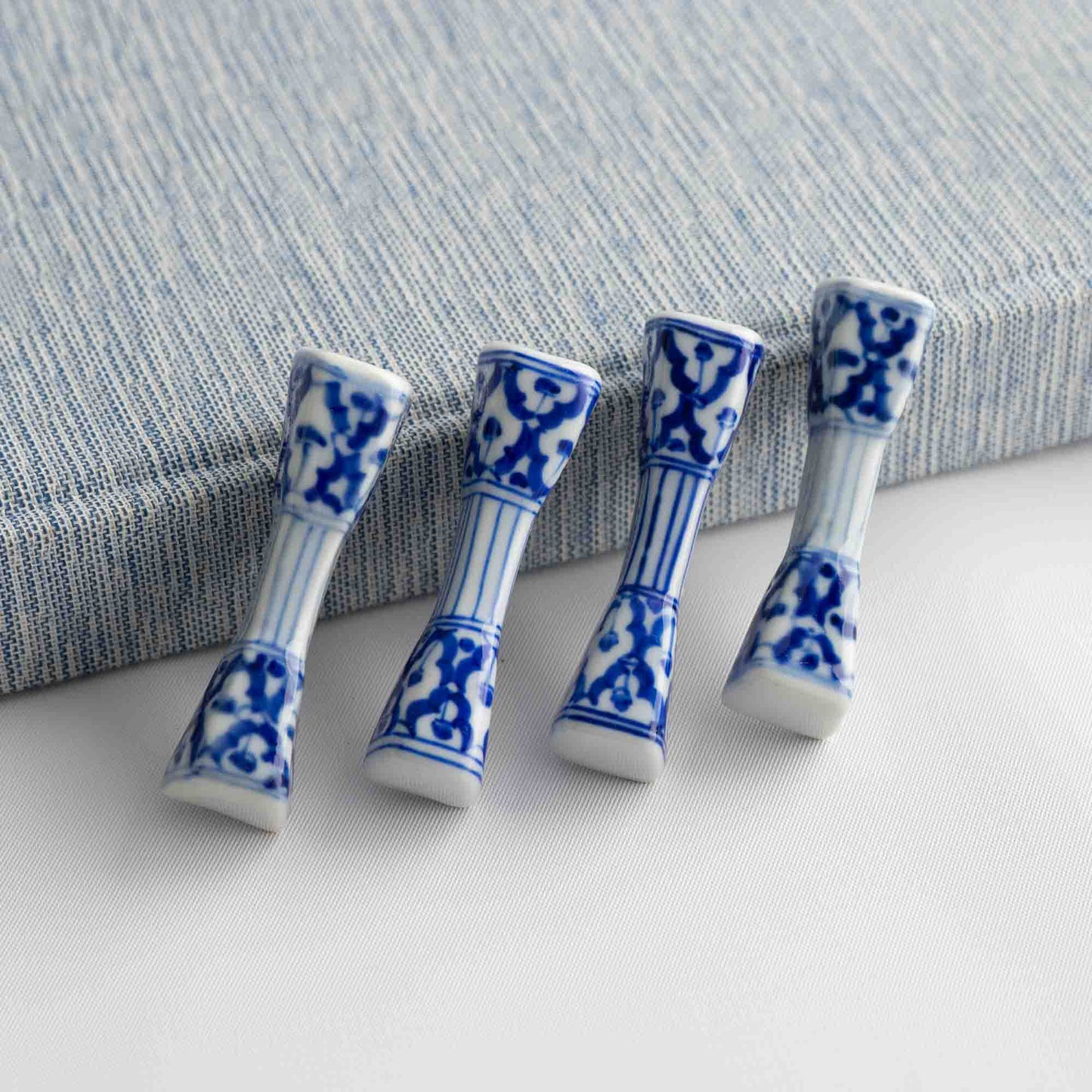 Set of four vintage porcelain chopstick rests in a traditional chinoiserie blue and white pattern