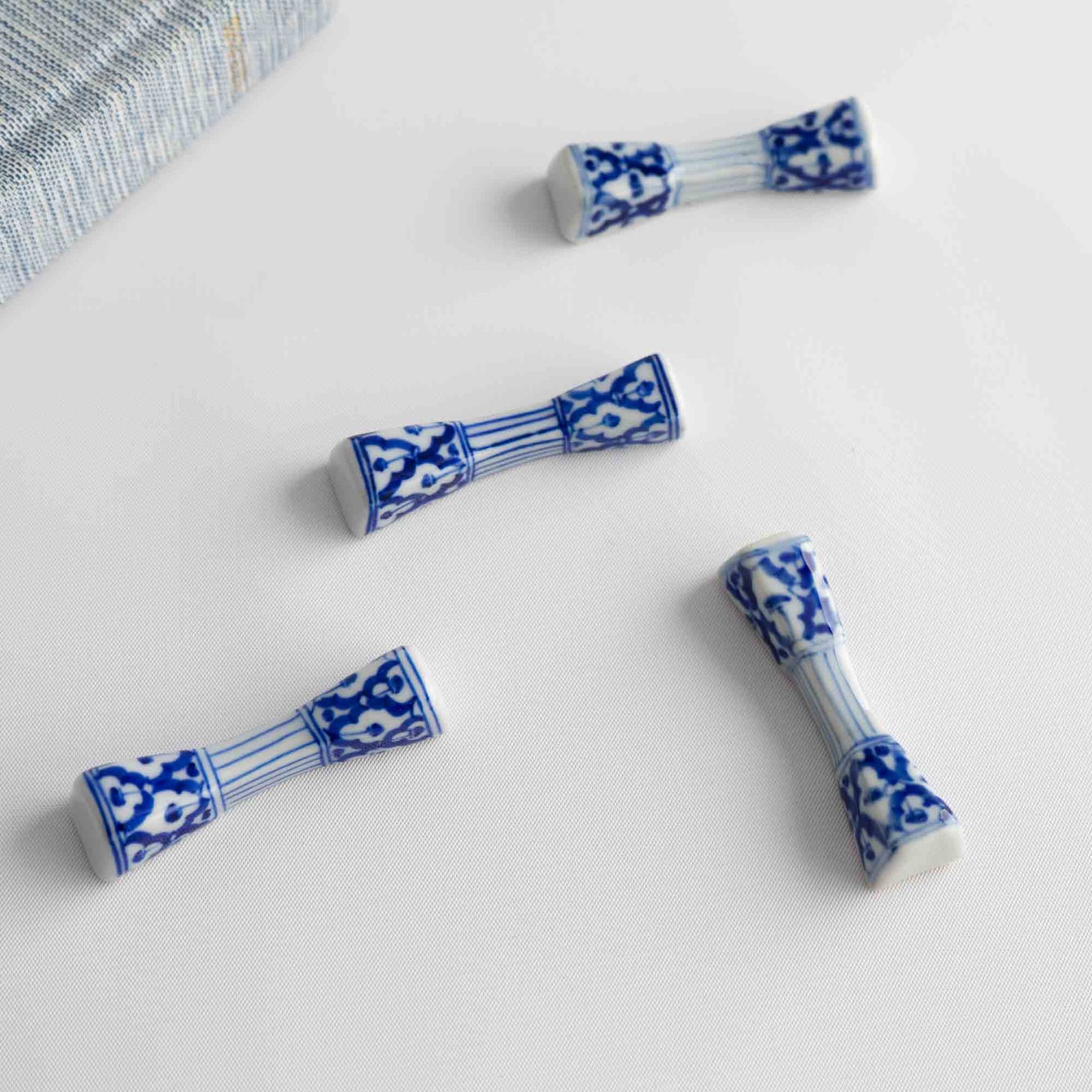 Set of four vintage porcelain chopstick rests in a traditional chinoiserie blue and white pattern