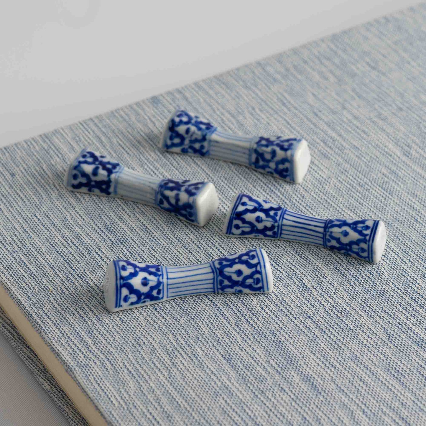 Set of four vintage porcelain chopstick rests in a traditional chinoiserie blue and white pattern