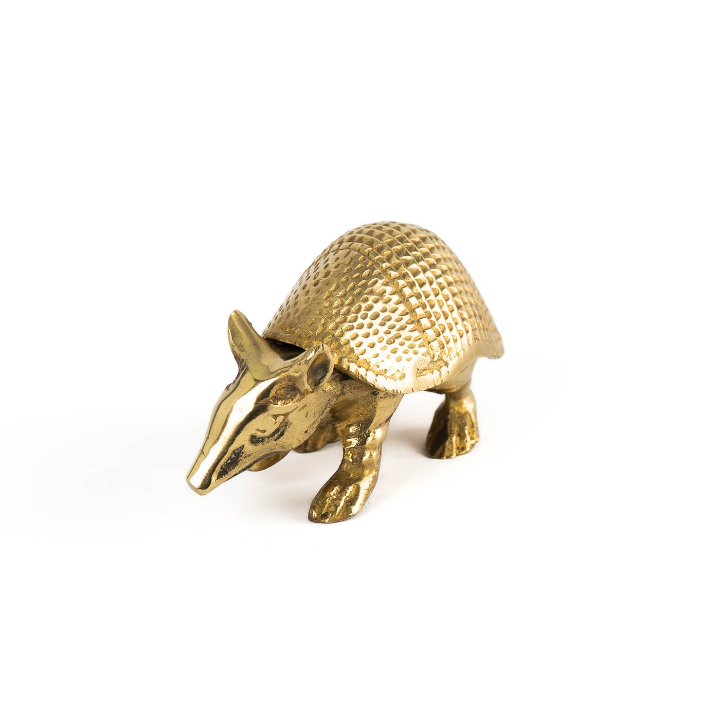 Vintage solid cast brass armadillo figurine with detailed segmented shell, circa 1970s–1980s