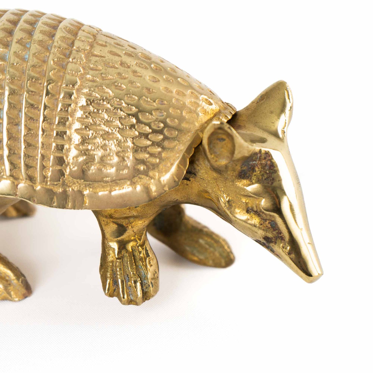 Vintage solid cast brass armadillo figurine with detailed segmented shell, circa 1970s–1980s - close up of face