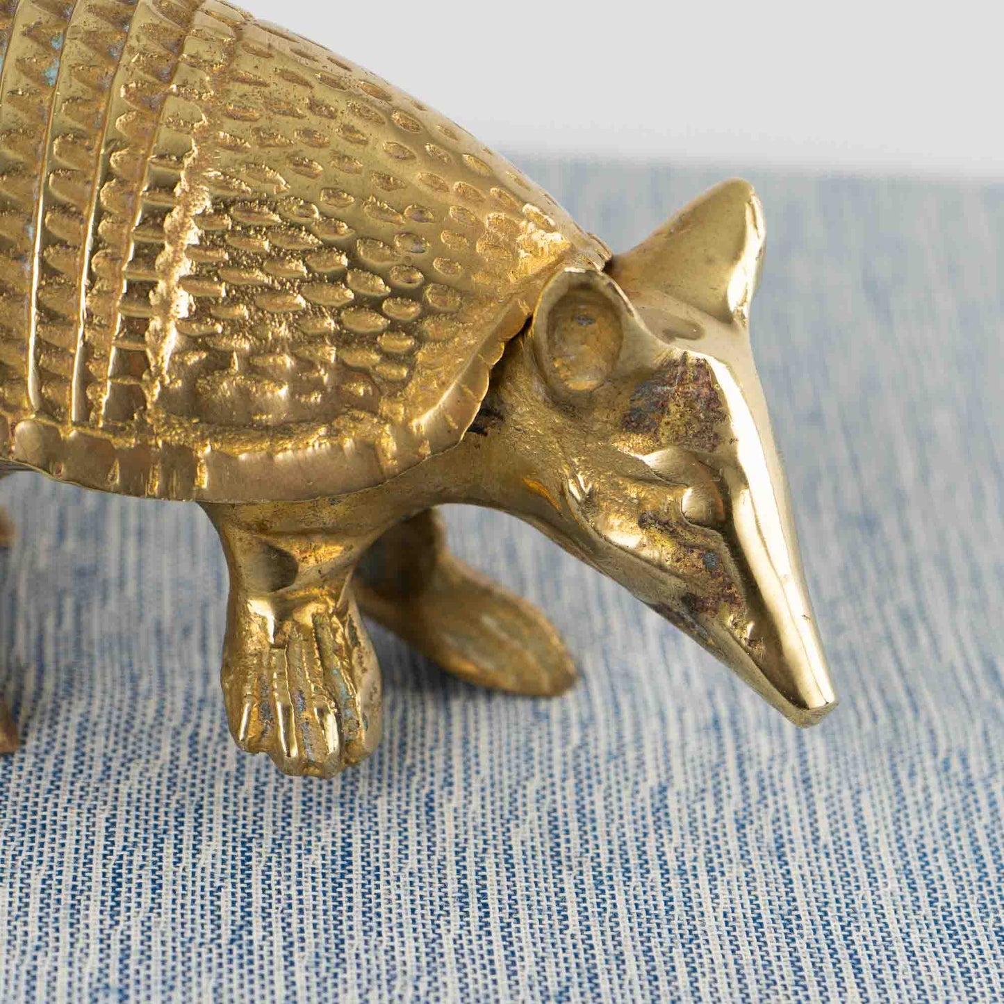 Vintage solid cast brass armadillo figurine with detailed segmented shell, circa 1970s–1980s