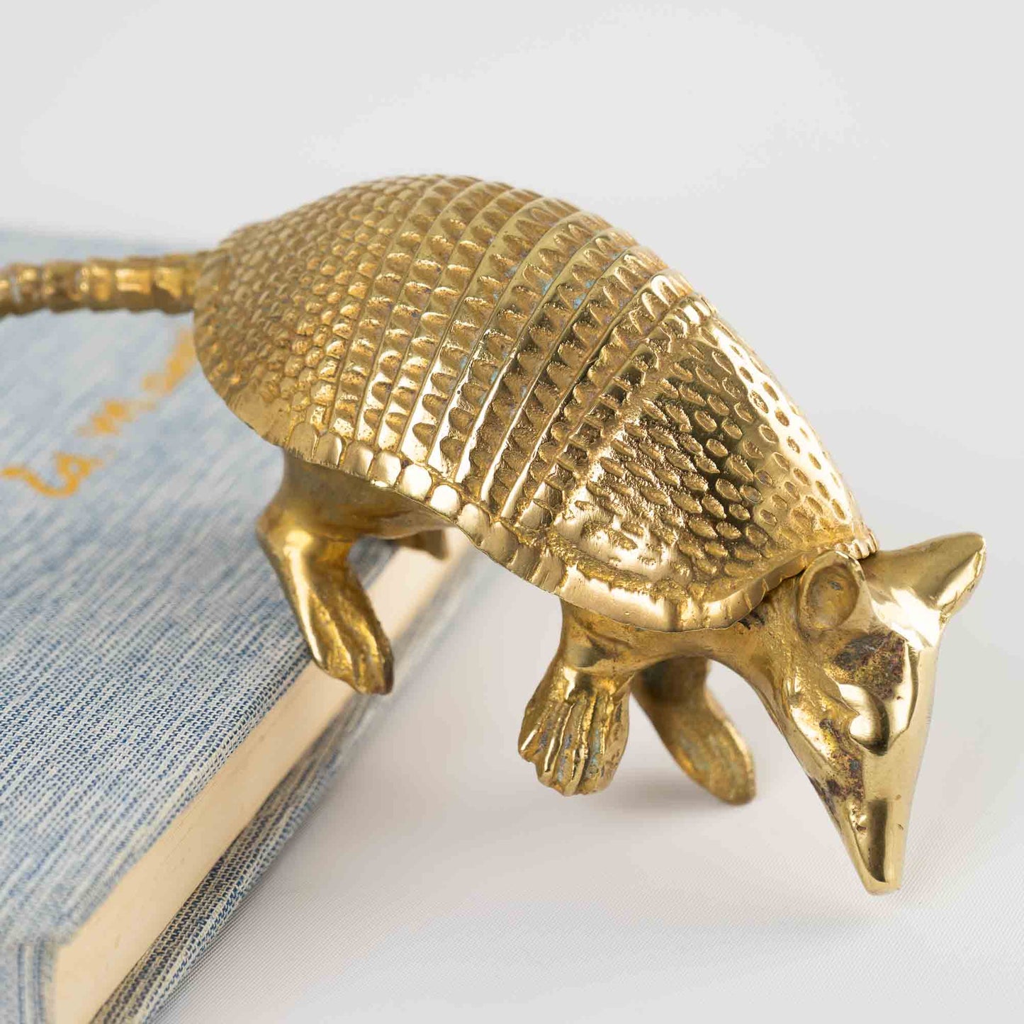 Vintage solid cast brass armadillo figurine with detailed segmented shell, circa 1970s–1980s