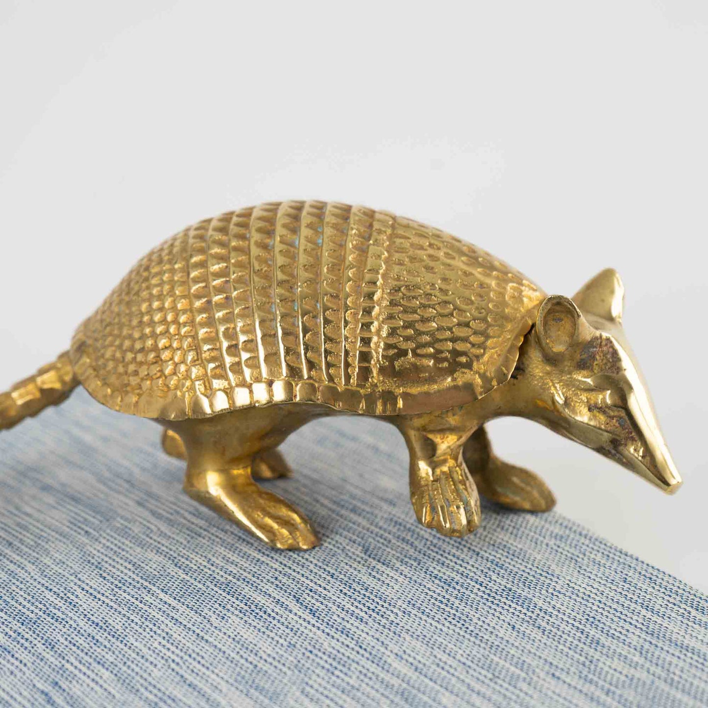 Vintage solid cast brass armadillo figurine with detailed segmented shell, circa 1970s–1980s