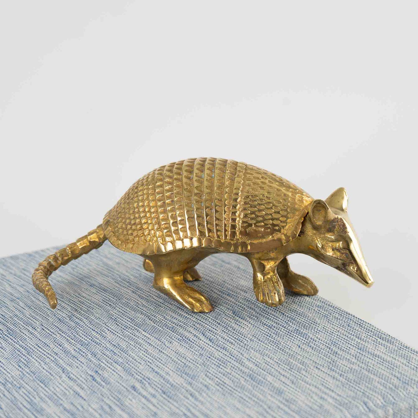 Vintage solid cast brass armadillo figurine with detailed segmented shell, circa 1970s–1980s