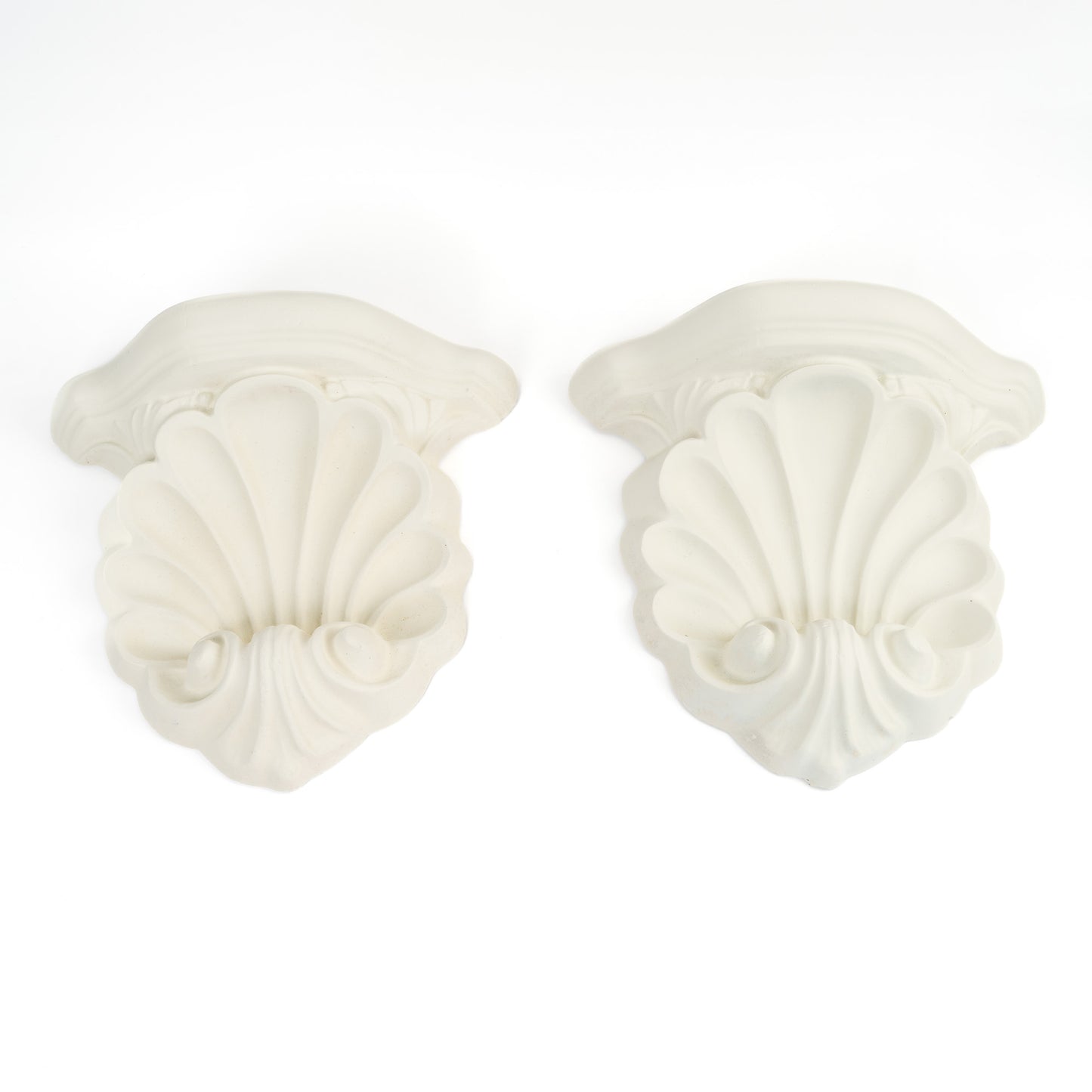 Pair of vintage white plaster shell scroll corbel wall shelves displayed side by side.