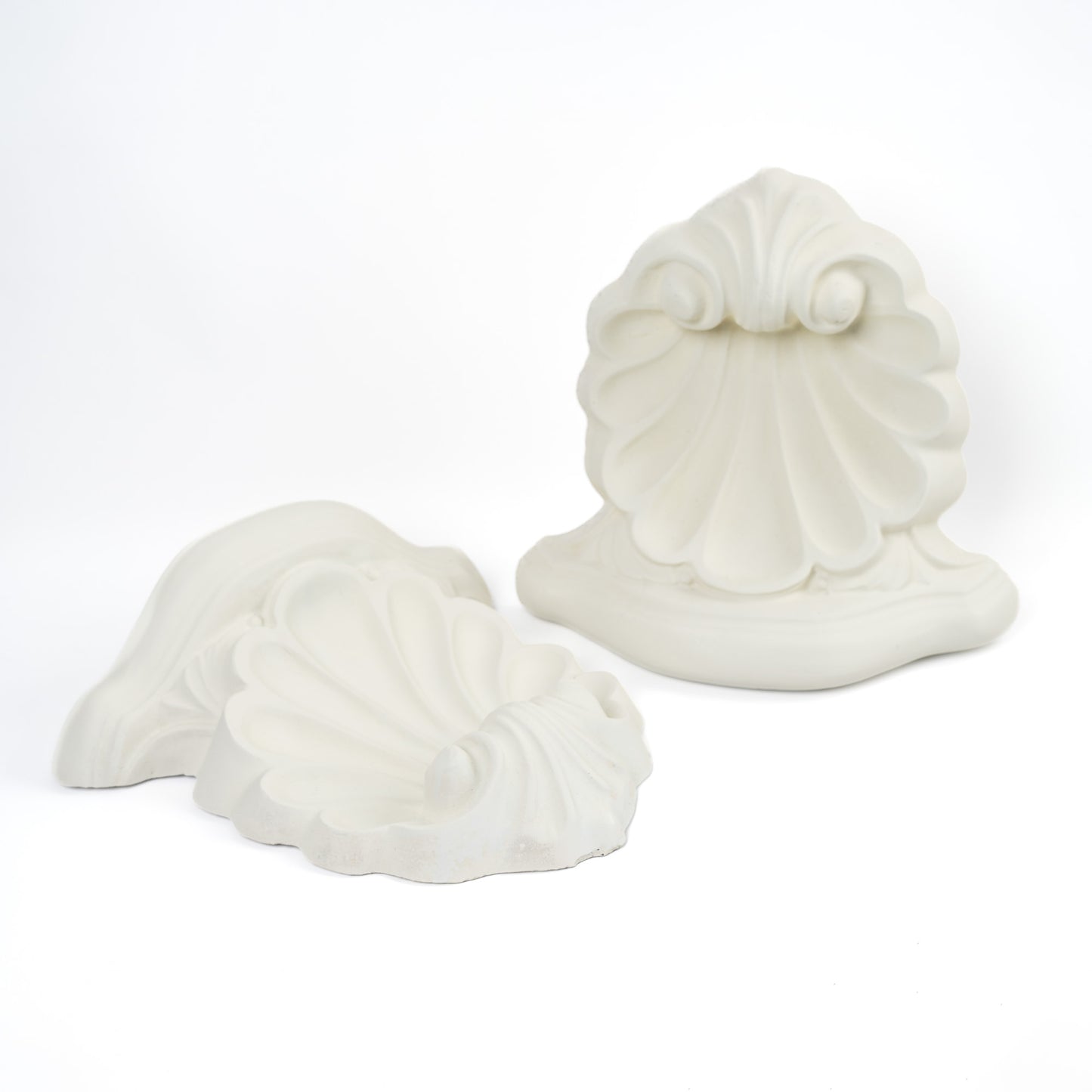 Pair of vintage white plaster shell scroll corbel wall shelves displayed side by side