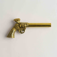 Vintage brass revolver-shaped corkscrew and bottle opener 