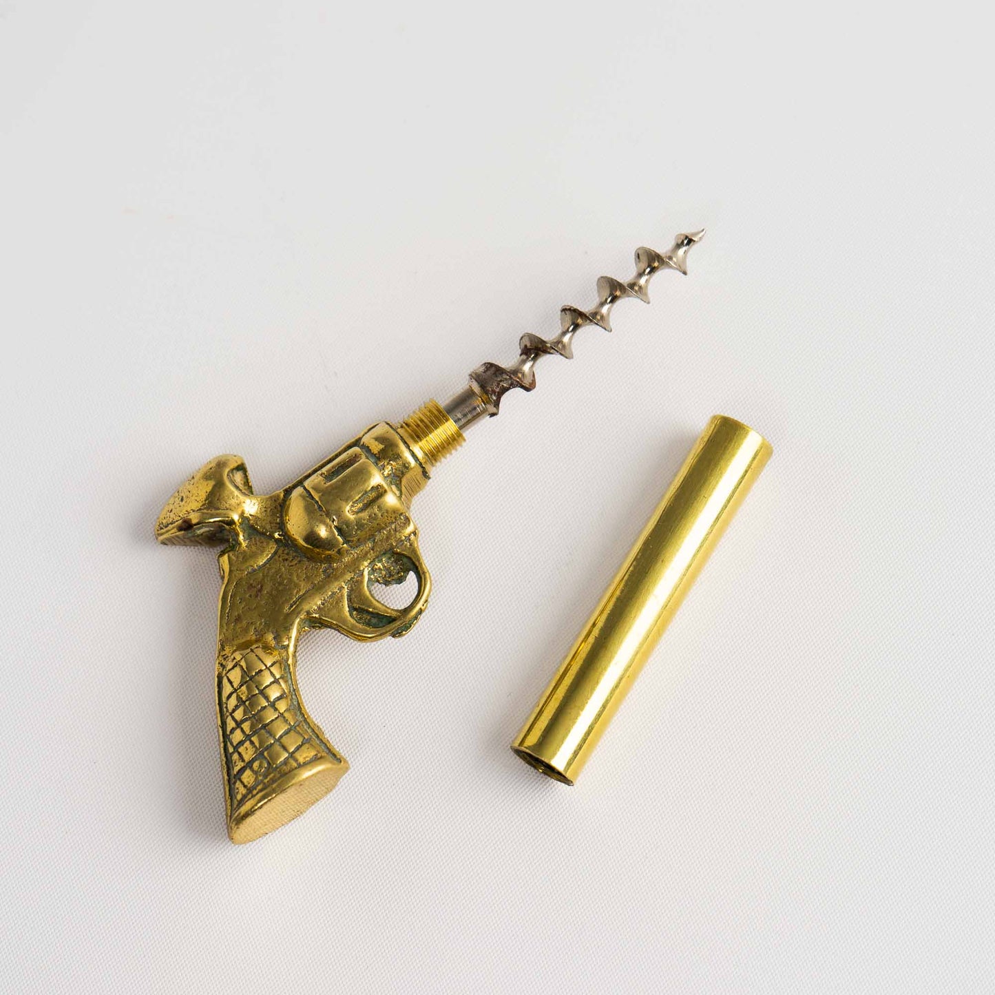 Vintage brass revolver-shaped corkscrew bottle opener 