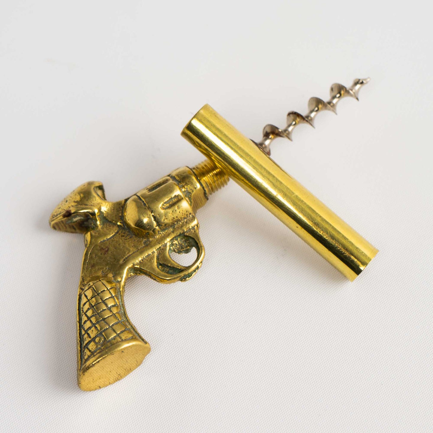 Vintage brass revolver-shaped corkscrew bottle opener 