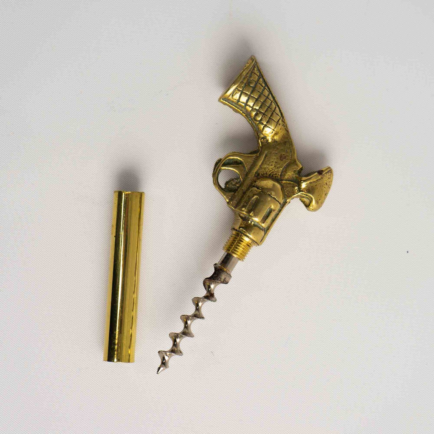 Vintage brass revolver-shaped corkscrew and  beer bottle opener 