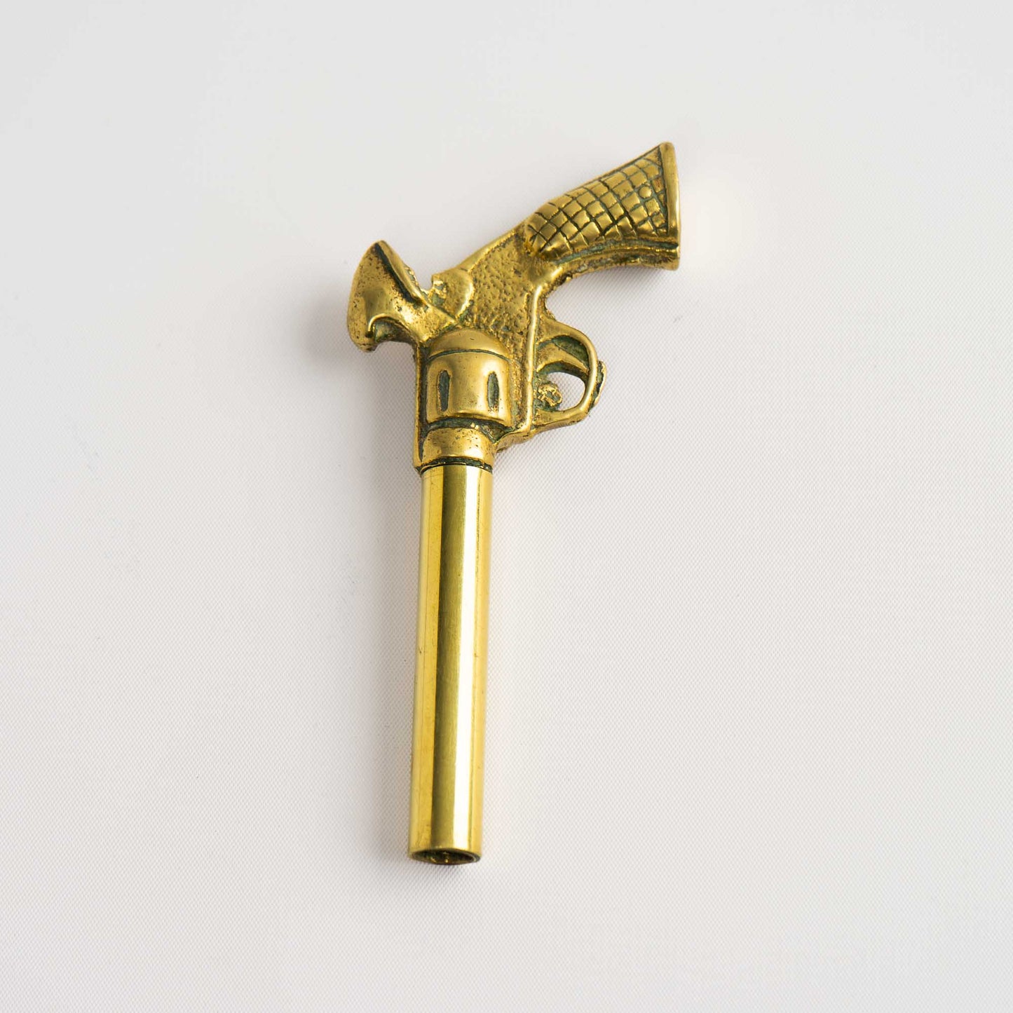 Vintage brass revolver-shaped corkscrew bottle opener 