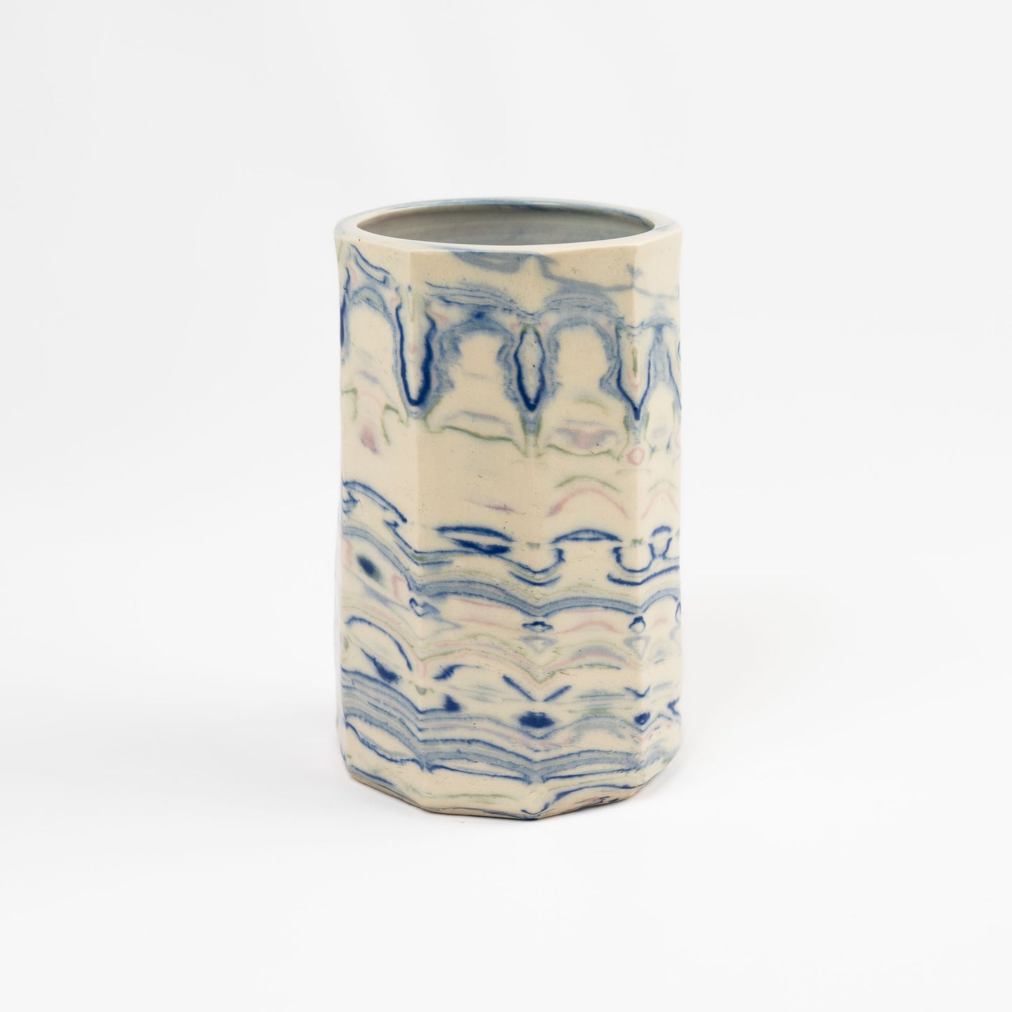 Vintage cylindrical Nerikomi marbled ceramic vase with swirling blue, green, and pink tones on an off-white ground, signed R  Durr and dated 1982. 