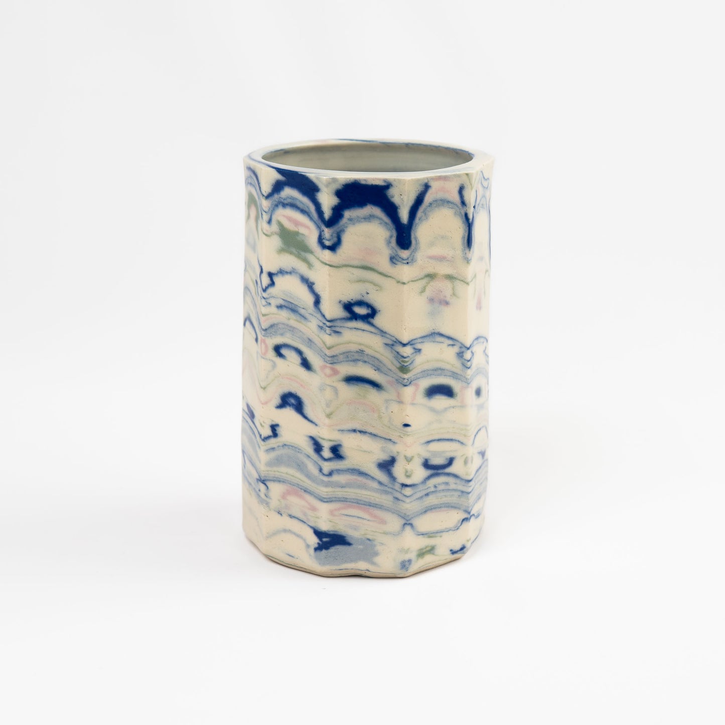 Vintage cylindrical Nerikomi marbled ceramic vase with swirling blue, green, and pink tones on an off-white ground, signed R DUNN and dated 1982. 
