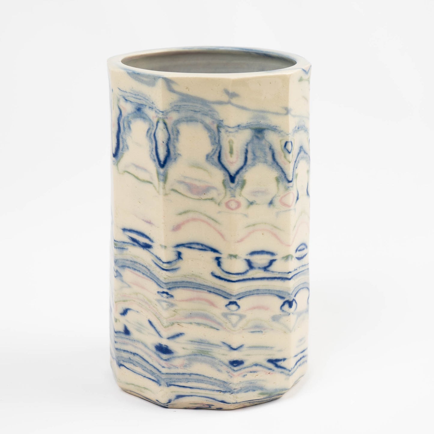 Vintage cylindrical Nerikomi marbled ceramic vase with swirling blue, green, and pink tones on an off-white ground, signed and dated 1982.