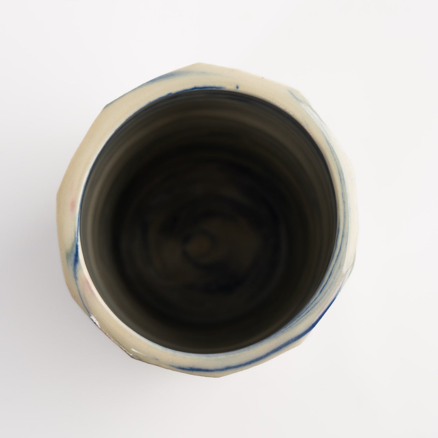 Vintage cylindrical Nerikomi marbled ceramic vase with swirling blue, green, and pink tones on an off-white ground, signed and dated 1982.