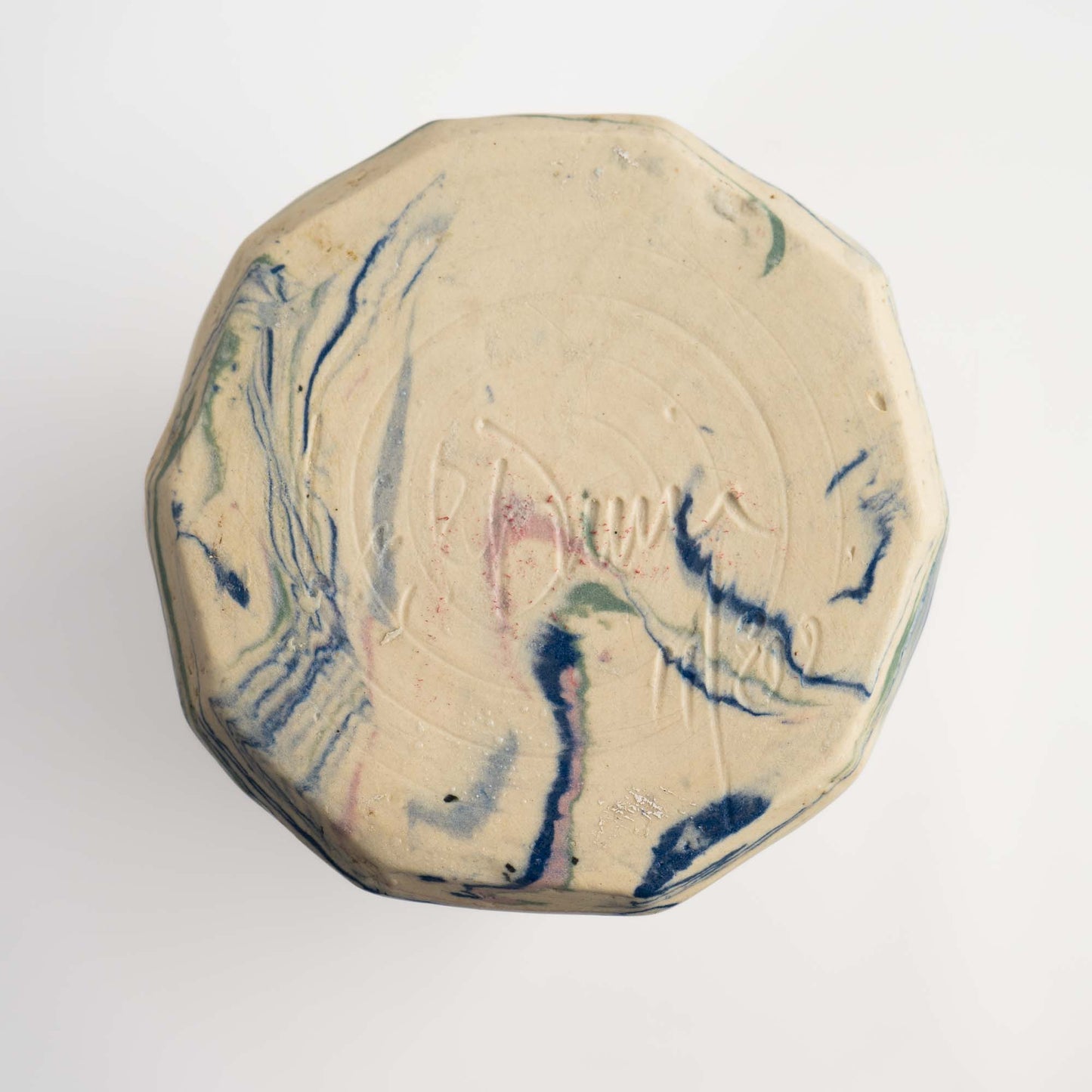 Base of vintage ceramic vase showing signature reading 