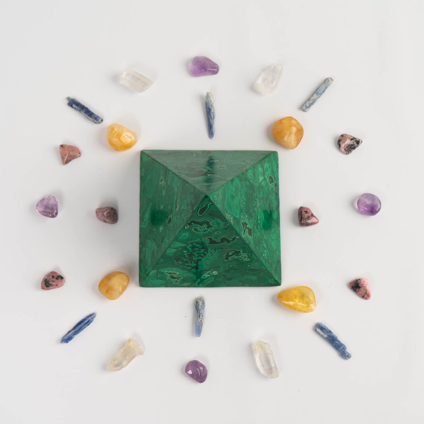 green malachite pyramid sculpture in a prosperity crystal grid